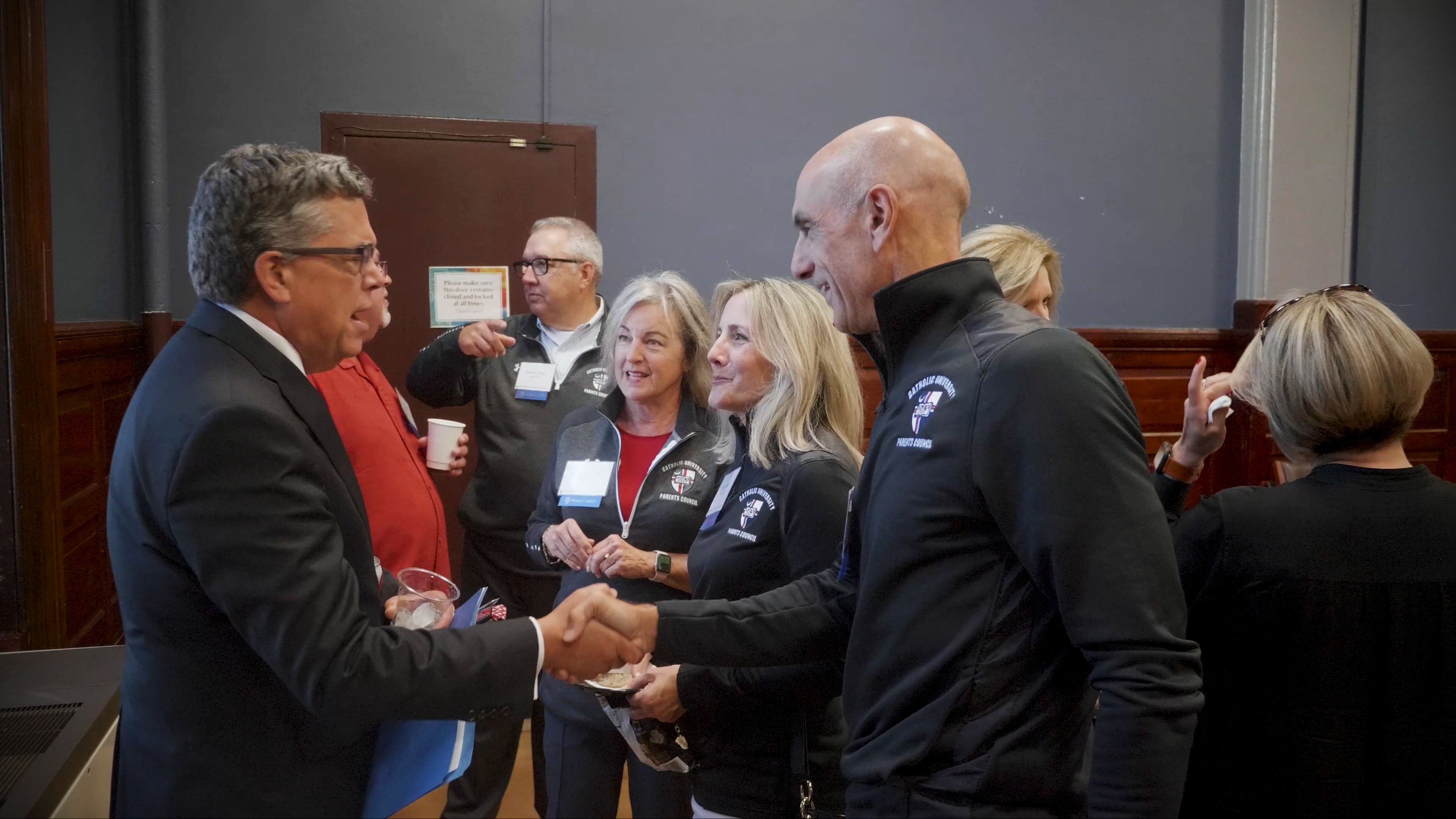 Parents talking with President John Garvey